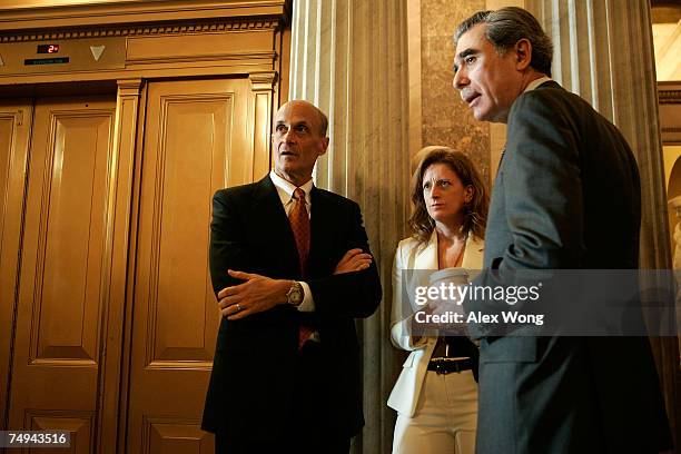 Commerce Secretary Carlos Gutierrez and Homeland Security Secretary Michael Chertoff wait to lobby senators prior to a cloture vote on an immigration...