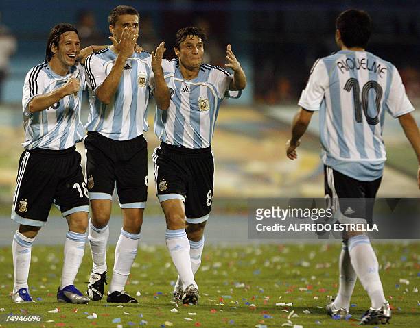 Argentine midfielder Lionel Messi, forward Hernan Crespo and defender Javier Zanetti celebrate with their teammate midfielder Juan Roman Riquelme...