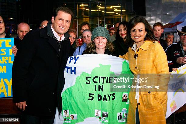 Today show hosts Lisa Wilkinson and Karl Stefanovic pose with a fan off-air as part of the Today Show 25th birthday celebrations at Federation Square...