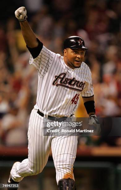 Carlos Lee of the Houston Astros reacts after hitting a game winning grand slam in the 11th inning against the Colorado Rockies on June 28, 2007 at...