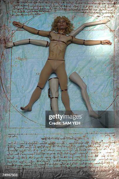 Man plays as the Vitruvian Man during the exhibition of the Renaissance Man Leonardo Da Vinci's Scientific Code at the National Taiwan Science...