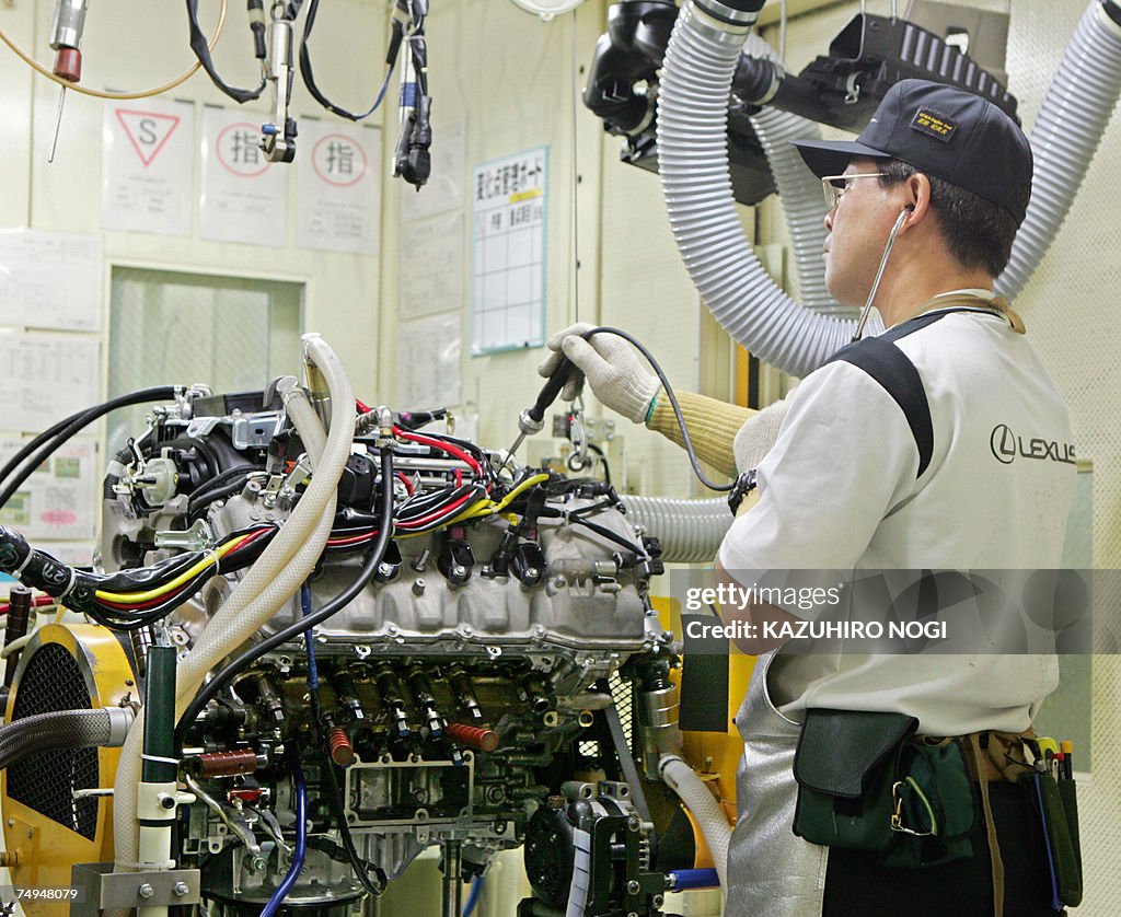 A worker at Japan's auto giant Toyota mo...