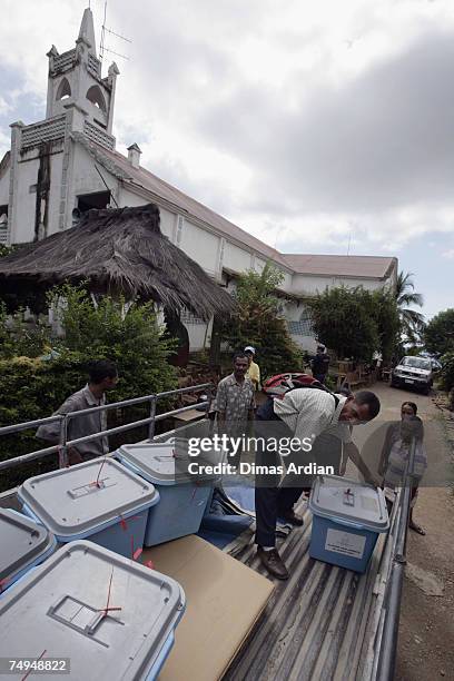 Election officers unload ballot boxes from a truck after it arived in the Balibar district amidst high tension one day before elections June 29, 2007...