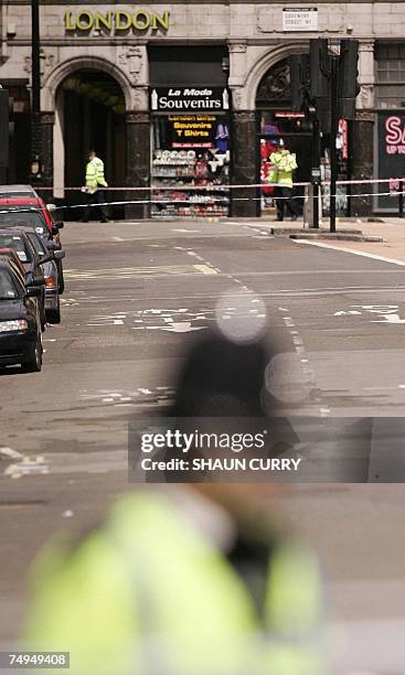 London, UNITED KINGDOM: British police officers guard the scene where a Mercedes car in what police said contained a "potentially viable explosive...