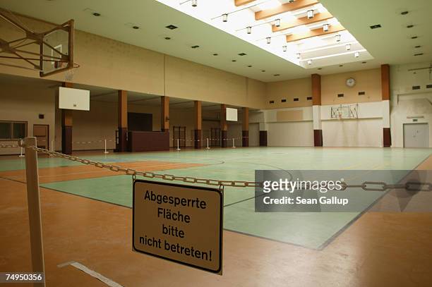 Sign warns visitors from walking across a former basketball court once used by members of the United States Air Force at Tempelhof Airport June 29,...
