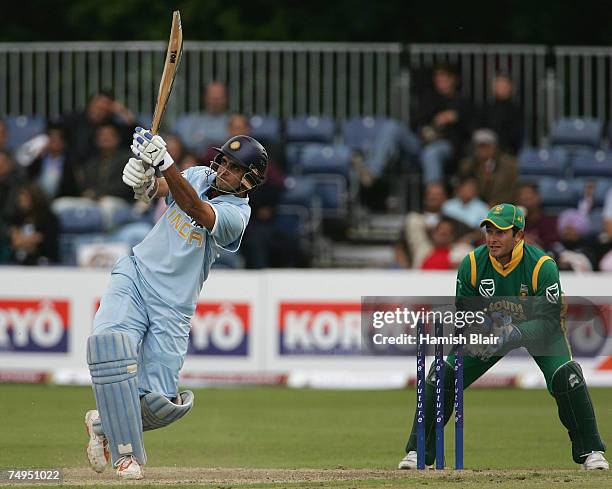 Sourav Ganguly of India hits out with Mark Boucher of South Africa looking on during the second One Day International match between South Africa and...