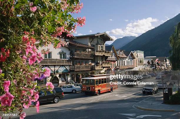 usa, washington state, chelan county, leavenworth, traffic in street near cascade mountains - leavenworth washington stock pictures, royalty-free photos & images