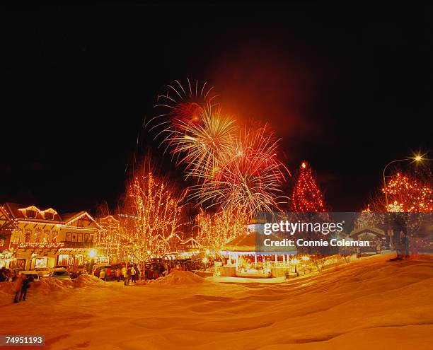 fireworks over illuminated, snow covered park - leavenworth washington 個照片及圖片檔