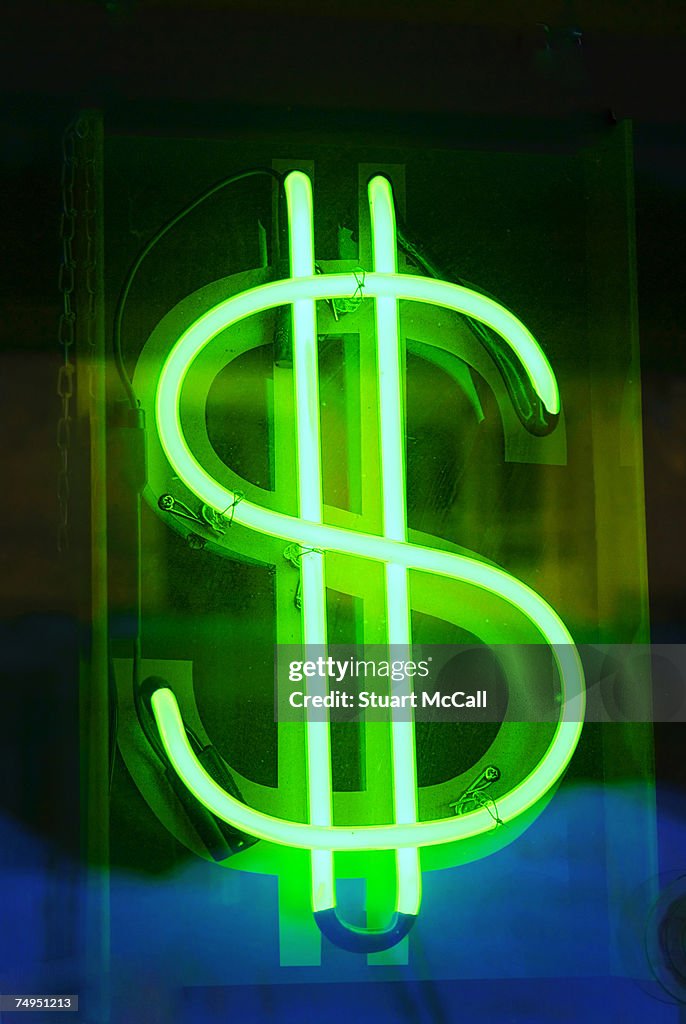 Neon dollar sign in shop window, close-up