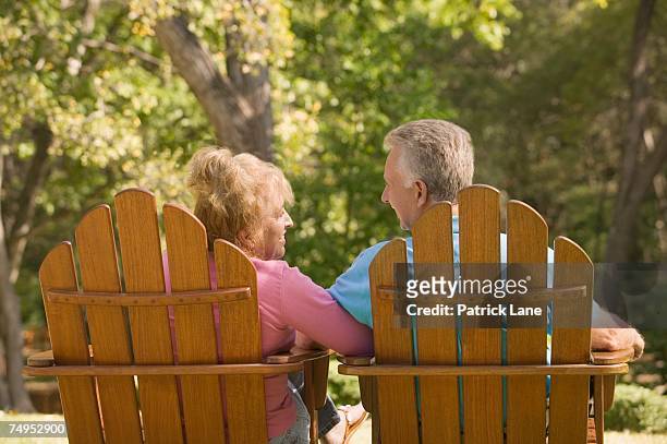 couple relaxing - adirondack chair closeup stock pictures, royalty-free photos & images