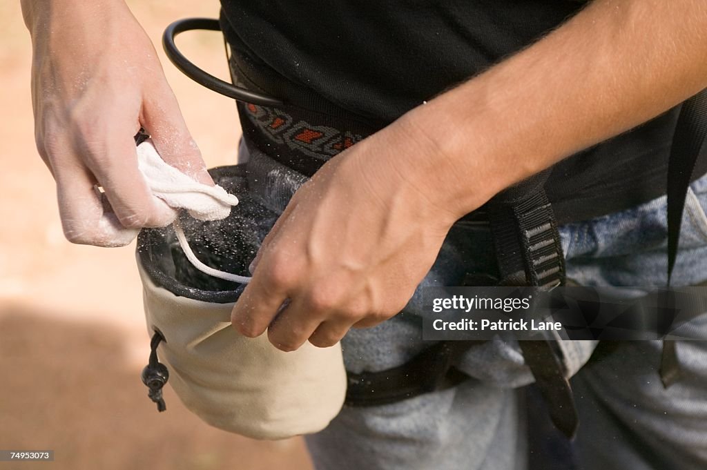 Rock climber with chalk bag and chalk