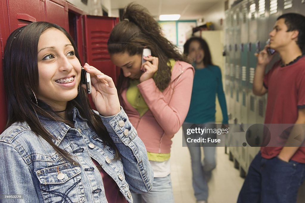 School kids on cell phones between classes