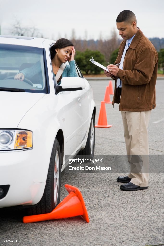 African teenager running over traffic cone at drivers test