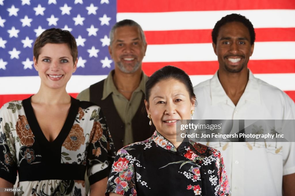 Multi-ethnic people standing in front of American flag