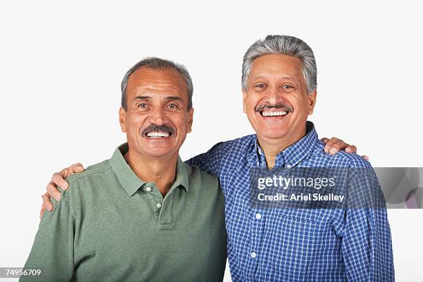 hispanic adult brothers hugging - old brother stock pictures, royalty-free photos & images