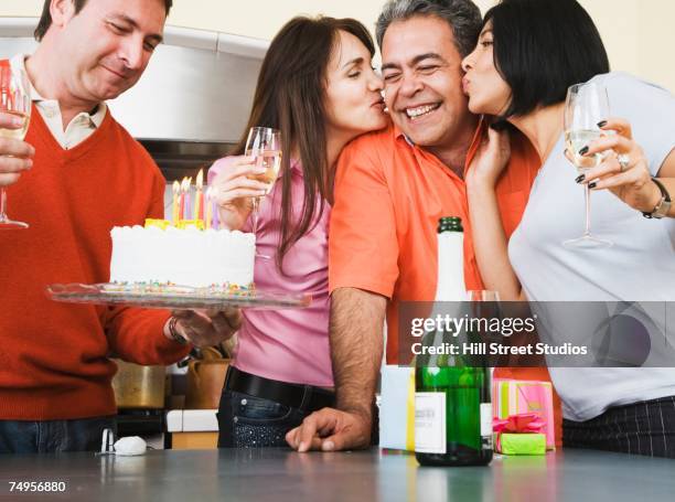 middle-aged friends at birthday party - man giving cake candle stock pictures, royalty-free photos & images