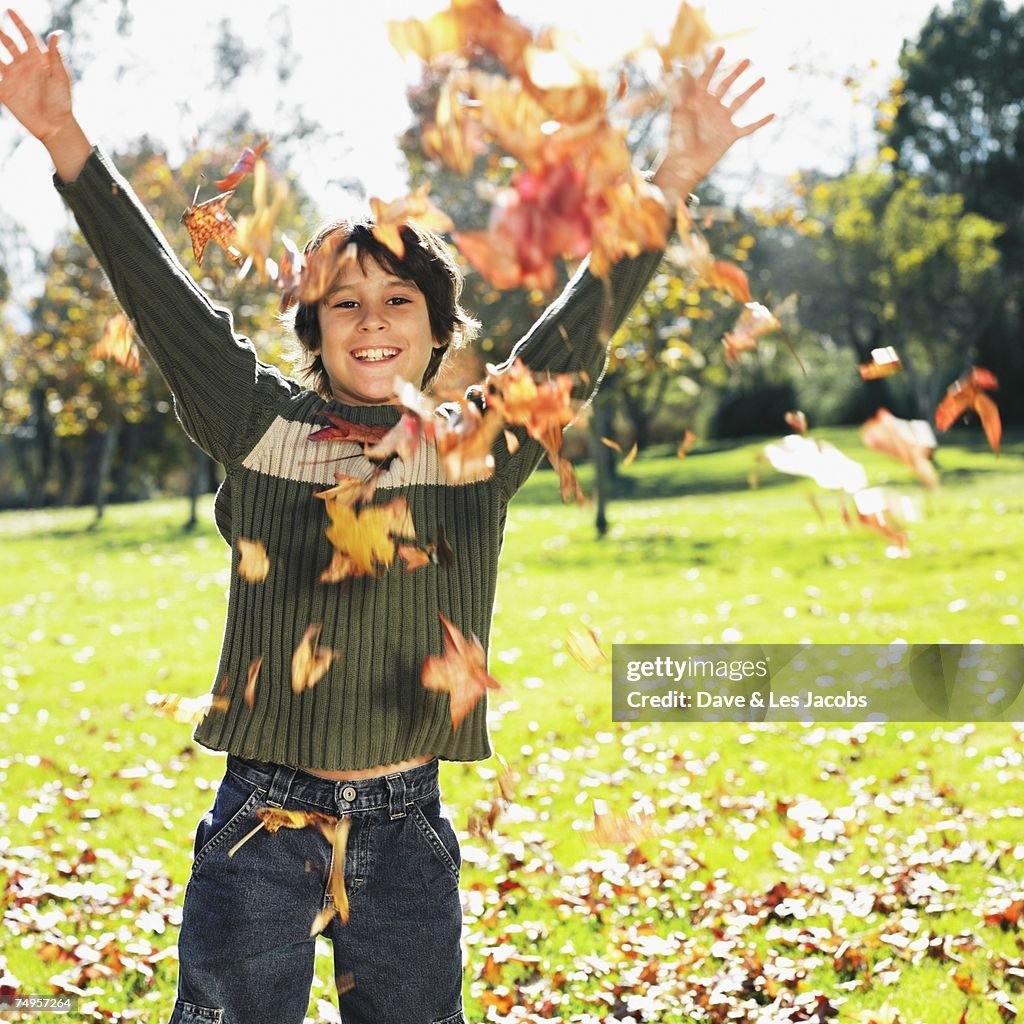 Getty Racing Fall Images Mixed Race Boy Playing In Autumn Leaves High-Res Stock Photo - Getty Images