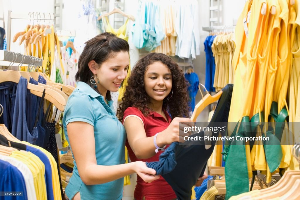 Multi-ethnic teenage girls in clothing store