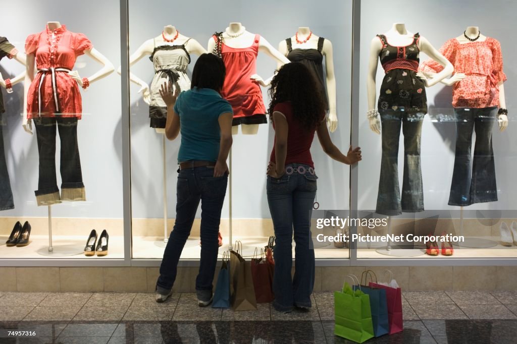 Multi-ethnic teenage girls window shopping