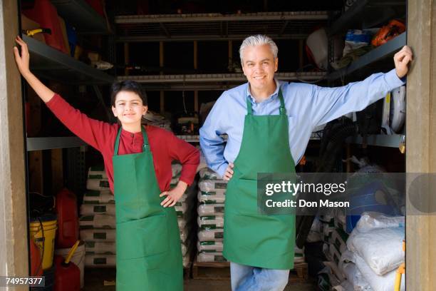 hispanic father and son working at garden center - großvater vater sohn business stock-fotos und bilder