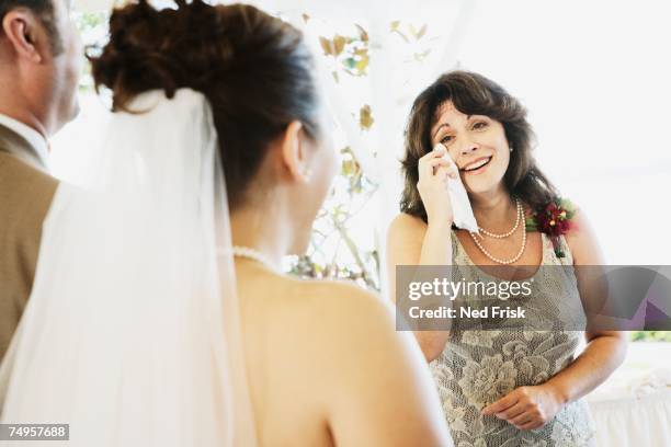 crying woman watching bride walk down aisle - tissue stockfoto's en -beelden