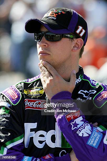 Denny Hamlin, driver of the FedEx Ground Chevrolet, looks on in pit row during qualifying for the NASCAR Nextel Cup Series Lenox Industrial Tools 300...