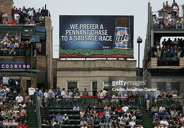 Billboard is visible on the roof of a building outside of Wrigley Field during a game between the Chicago Cubs and the Milwaukee Brewers at Wrigley...