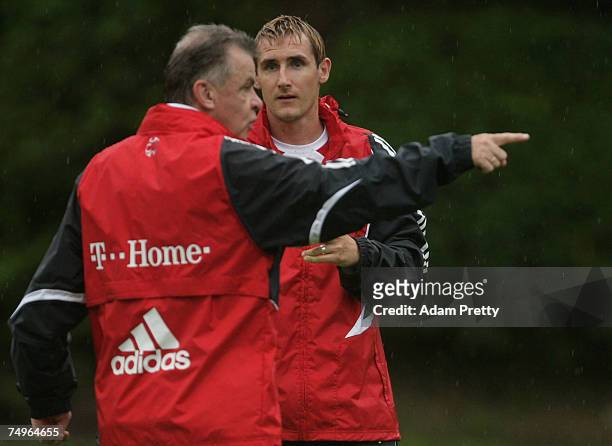 Miroslav Klose of Bayern Munich receives instructions from manager Ottmar Hitzfeld during a training session at Hong Kong stadium on June 30, 2007 in...