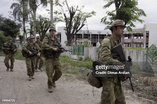 Peacekeeping soldiers from Australia patrol the street, June 30, 2007 in Dili, East Timor. East Timor goes to the polls for a third time this year in...