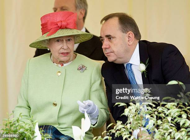 Queen Elizabeth II and Scotland's First Minister Alex Salmond watch the Riding procession go past at the opening of the third session of the Scottish...