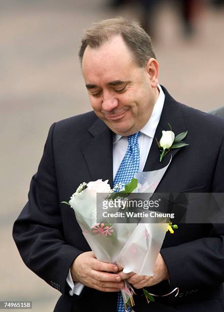 Scotland's First Minister Alex Salmond is given a bouquet of flowers at the opening of the third session of the Scottish Parliament on June 30, 2007...