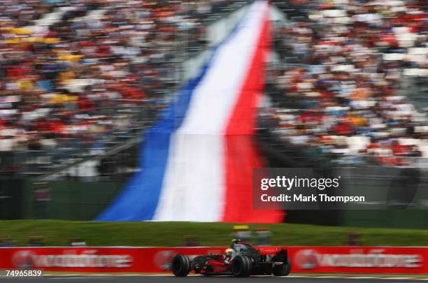 Lewis Hamilton of Great Britain and McLaren Mercedes drives on his way to setting the second fastest time during qualifying for the French Formula...