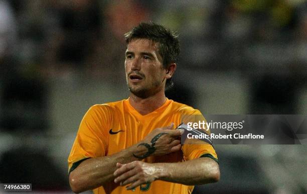 Harry Kewell of Australia puts on the captain's armband after captain Mark Viduka was substituted during the International Friendly match between...