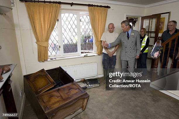 Prince Charles, Prince of Wales sees flood damage in the home of the Breeze family during a visit to flood effected areas on June 29, 2007 in...