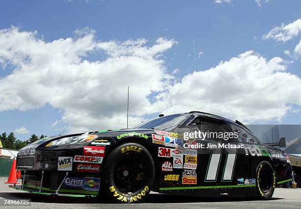 Denny Hamlin, driver of the FedEx Ground Chevrolet, drives in the garage area during practice for the NASCAR Nextel Cup Series Lenox Industrial Tools...