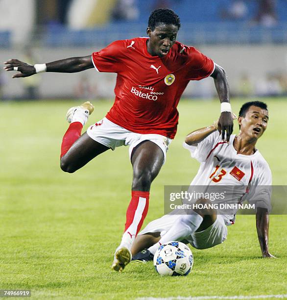 Bahrain football player Abdulla Baba Fatadi fights for the ball with Vietnamese opponent Mai Tien Thanhduring a friendly soccer match at the My Dinh...