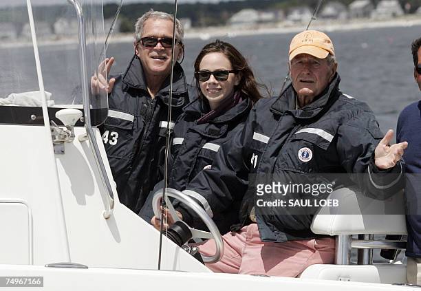President George W. Bush , holds up two fingers showing the number of fish he caught while out with his daughter, Barbara and his father, former US...