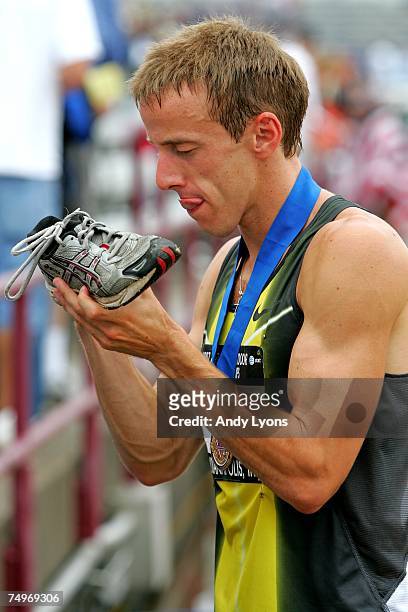 Alan Webb autographs a shoe after winning the men's 1500 meter run during day four of the AT&T USA Outdoor Track and Field Championships at IU...