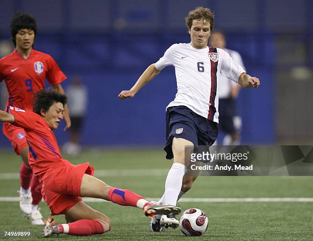 South Korea's Lee Chung-Yong tackles the ball away from United States' Michael Bradley as Lee Sang-Ho follows during a match between South Korea's...
