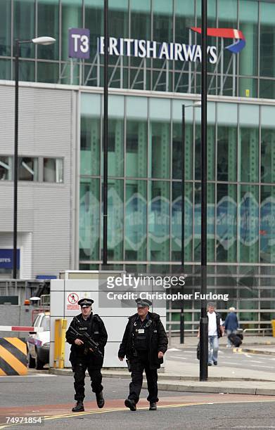 Armed police officers patrol the entrance to Terminal 3 of Manchester Airport on July 1, 2007 In London, England. Following this weeks terrorist...