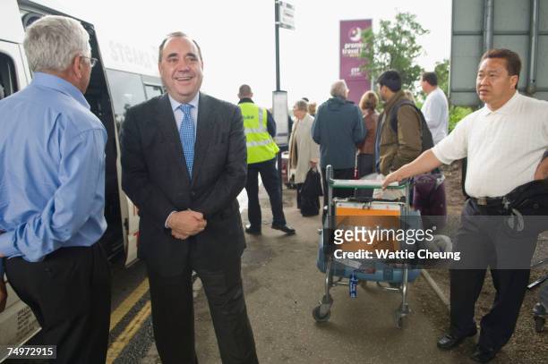 Scotland's First Minister, Alex Salmond, speaks to a passenger at Glasgow Airport, July 1 2007 in Glasgow, Scotland. Salmond spoke to the emergency...