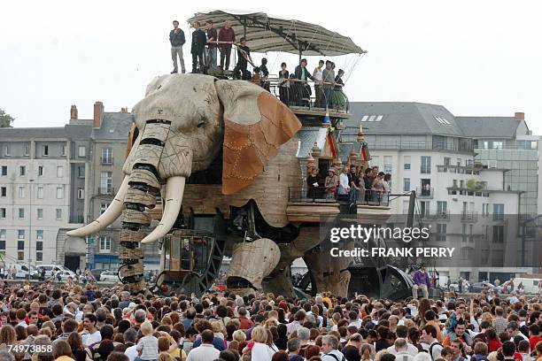 People gather around a 12-meter-high mechanical elephant 30 June 2007 in Nantes, western France. This giant elephant takes part in a cultural and...