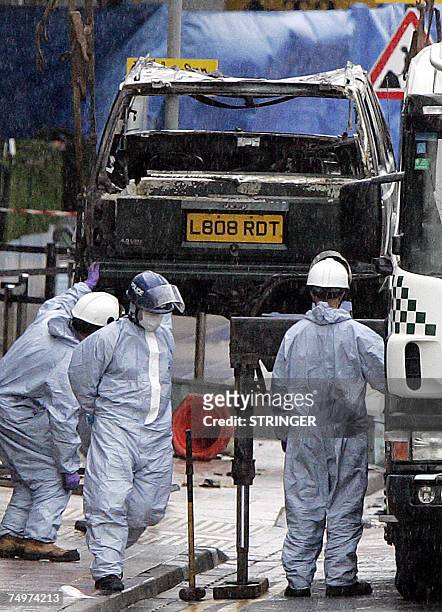The remain's of the burnt out jeep is lifted from the scene at Glasgow International Airport,01 July 2007 where a Jeep Cherokee rammed and burst into...