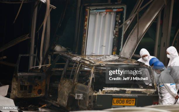 Police go over the scene at Glasgow Airport after a blazing car was driven into the airport's main terminal July 1, 2007 in Glasgow, Scotland....