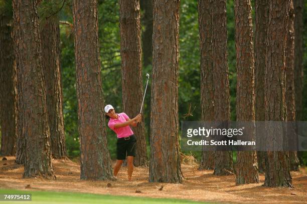 Lorena Ochoa of Mexico hits a shot from the trees on the tenth hole during the final round of the U.S. Women's Open Championship at Pine Needles...
