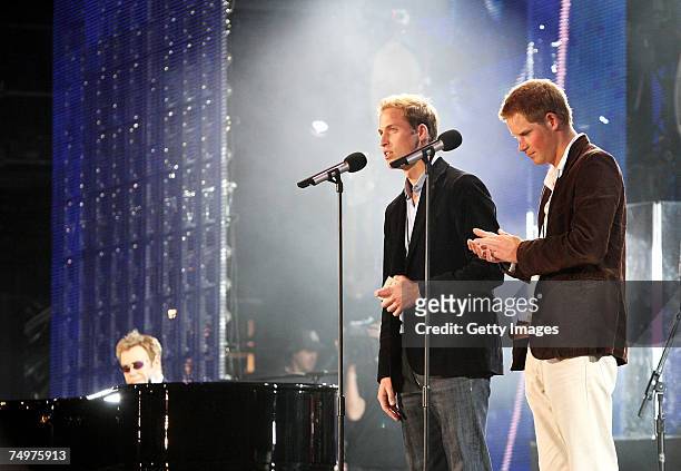 Their Royal Highnesses Prince William and Prince Harry speak on stage with Sir Elton John at the piano at the Concert for Diana at Wembley Stadium on...