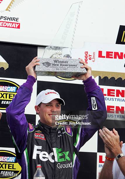 Denny Hamlin, driver of the FedEx Ground Chevrolet, celebrates in victory lane after winning the NASCAR Nextel Cup Series Lenox Industrial Tools 300...