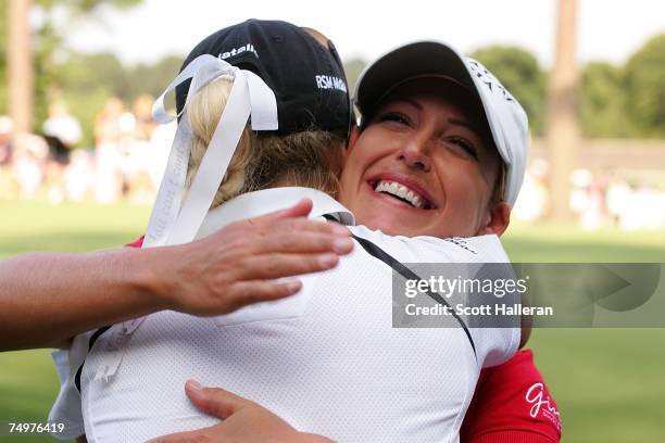 Cristie Kerr celebrates her two-stroke with Natalie Gulbis on the 18th green at the U.S. Women's Open Championship at Pine Needles Lodge & Golf Club...