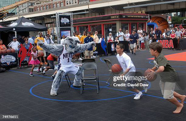New Jersey Nets mascot Sly the Fox plays a game of basketball musical chairs with participants at the NBA Nation Tour event at Pier 17 South Street...