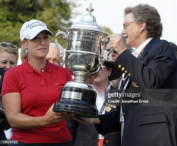 Cristie Kerr receives the trophy from Roberta Bolduc, USGA Women's Committee Chairman, after her 2-stroke victory at the U.S. Women's Open...